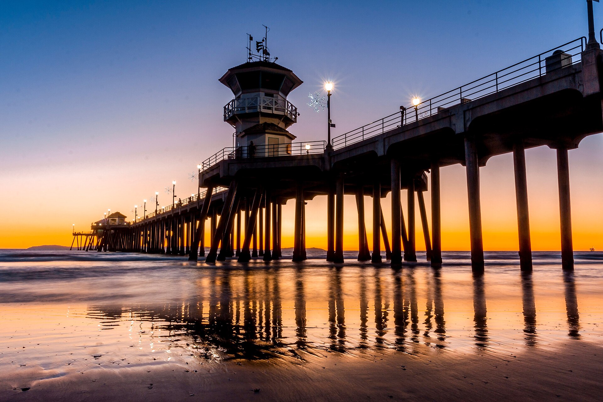 The Huntington Beach Pier reaching out over the Pacific at sunset
